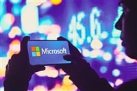 June 1, 2022, Brazil. In this photo illustration, a silhouetted woman holds a smartphone with the Microsoft Corporation logo displayed on the screen