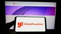 STUTTGART, GERMANY - Aug 23, 2021: Person holding cellphone with logo of US semiconductor company GlobalFoundries Inc. (GF) on screen in front of webpage. Focus on phone display. - Stock Editorial Photography