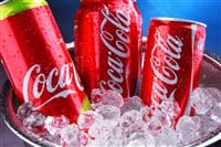 Cans of Coca-Cola in bucket with crushed ice - Stock Editorial Photography