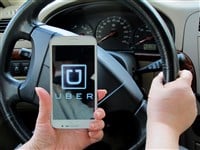 Uber logo on smartphone in car