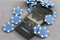 Blue poker chips on stock market chart background. High quality photo - stock image