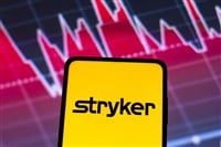 May 4, 2022, Brazil. In this photo illustration the Stryker Corporation logo seen displayed on a smartphone screen, with graphic representation of the stock market in the background