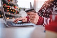 Woman shopping online at home - stock image