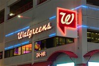 A picture of a Walgreens at night.