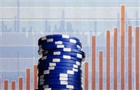 Photo of blue poker chips against a stock chart background