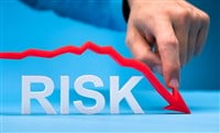 Photo of a finger pushing down a red chart arrow above the word RISK