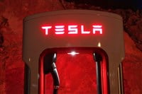 Tesla supercharger for electric cars at night - Stock Editorial Photography