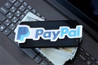 TERNOPIL, UKRAINE - SEPTEMBER 6, 2022 Paypal paper logotype lies on black laptop keyboard with US dollar bills. Payoneer is American financial services company provides online money transfer — Stock Editorial Photography