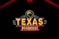 WOODBURY, MN, USA - DECEMBER 4, 2023: Texas Roadhouse restaurant exterior and trademark logo at night. - Stock Editorial Photography