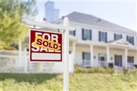 Sold Home For Sale Sign in Front of New House - stock image