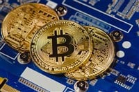 Close up view of arranged golden bitcoins on computer motherboard — Stock Editorial Photography