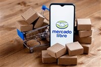 Kazan, Russia - Oct 22, 2021: Mercado Libre is Argentine company that operates online marketplaces. Smartphone with Mercado Libre logo on the screen, shopping cart and parcels. - Stock Editorial Photography