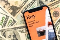 Poltava, Ukraine - April 28, 2022: Etsy shopping app logo on mobile phone screen. Business background with dollar money banknotes — Stock Editorial Photography