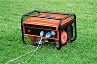 Portable electric generator on the green grass outdoors — Photo