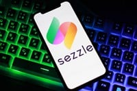 Close up view of the smartphone on neon keyboard with sezzle logo — Stock Editorial Photography