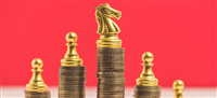 Chess on stack of money coins and red background — Photo