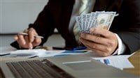 businessman counting banknotes on wooden table with calculator and laptop Concept of counting money. Salary. Paying employees in a company office. — Photo