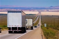 Delivery trucks on a highway. — Photo