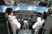 Photo of pilots at the flight deck control station.