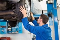 Mechanic adjusting the tire wheel - stock image