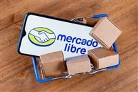 Kazan, Russia - Oct 22, 2021: Mercado Libre is Argentine company that operates online marketplaces. Smartphone with Mercado Libre logo on the screen, shopping cart and parcels. - Stock Editorial Photography