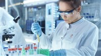 Female Research Scientist Uses Micropipette Filling Test Tubes i - stock image