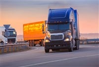 Trucks goes on highway on sunset - stock image