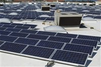 Array of solar panels on roof with exhaust fan