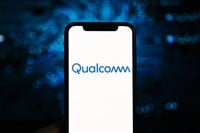 Qualcomm logo on the iPhone screen. Qualcomm is a company that manufactures processors for mobile devices. — Photo by nikkimeel