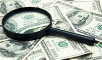 Magnifying glass and money - business background