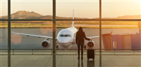 Young woman with suitcase in the departure hall at airport. Travel concept. — Photo