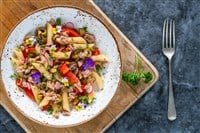 Warm tuna and roasted pepper pasta salad with pistachio nuts - overhead view