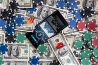 Money and smartphone with sports bet application. High quality photo - stock image