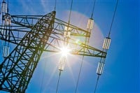 Power line with sun - stock image