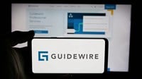 Stuttgart, Germany - 11-14-2024: Person holding cellphone with logo of US company Guidewire Software Inc. on screen in front of business webpage. Focus on phone display. — Stock Editorial Photography